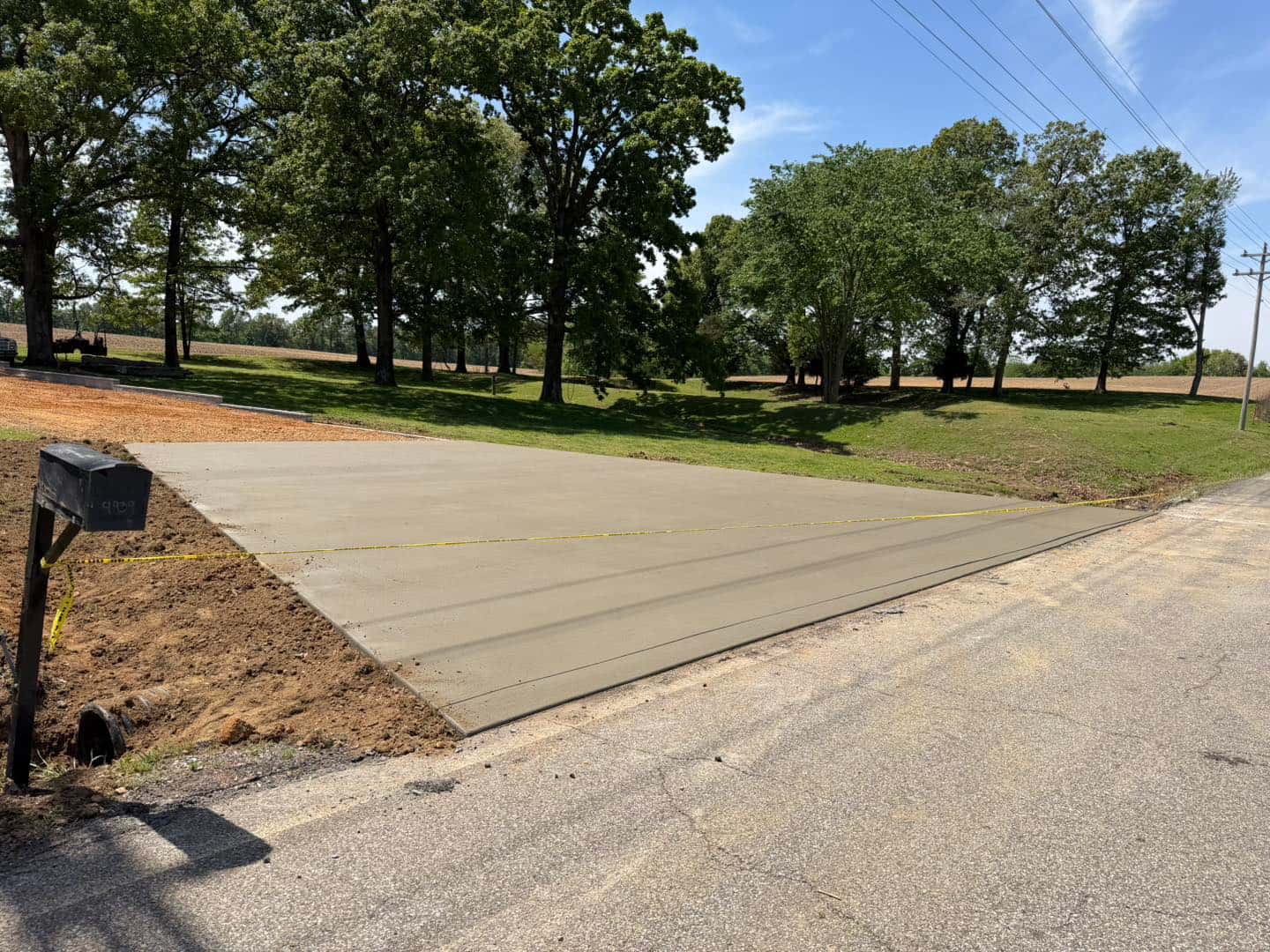 Freshly poured concrete driveway with clean edges by Four Rivers near Paducah, KY